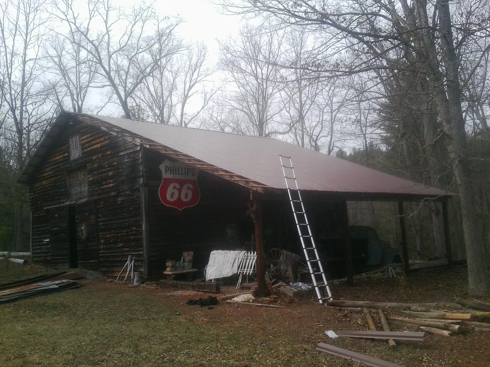 New metal roof on an open sided timber barn with a vintage sign in Moab